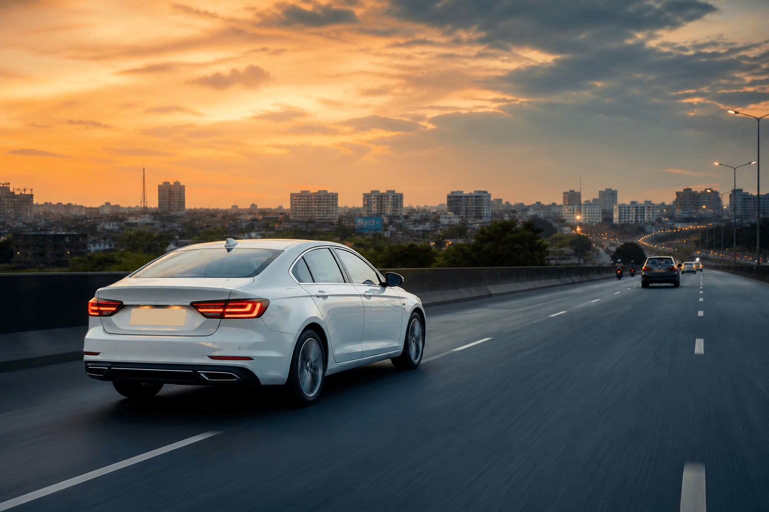 White Rathya sedan on the highway toward a soft Patna city skyline